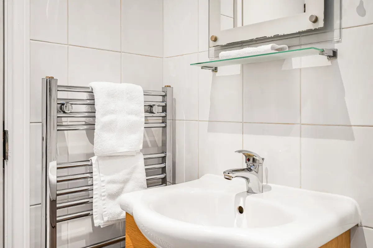 Bathroom at Casa Cribs with clean towels and a modern sink area.