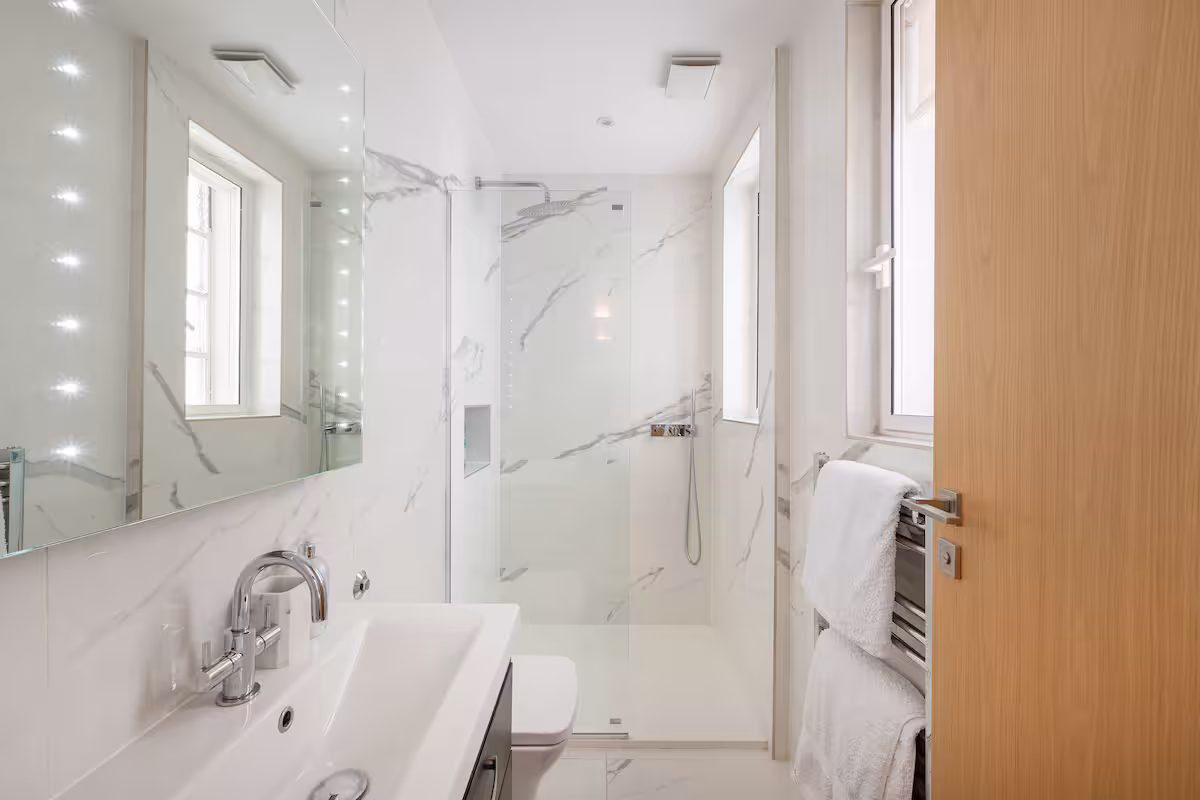 Luxurious bathroom at Casa Cribs with sleek marble finishes and elegant fixtures.