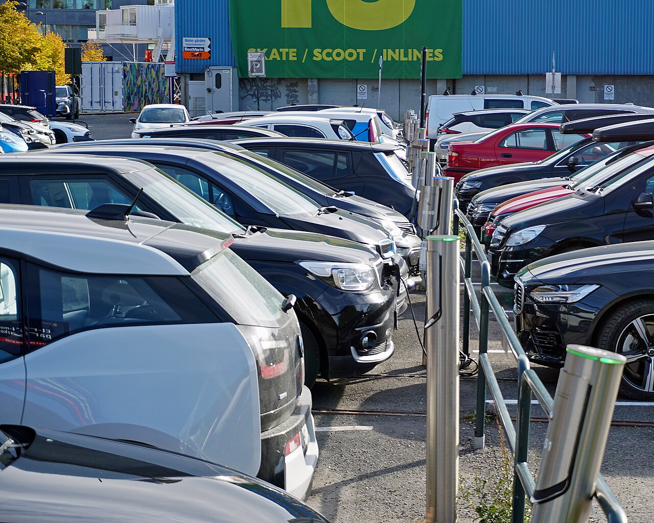 A parking lot full of electric cars plugged into charging posts in Oslo, Norway