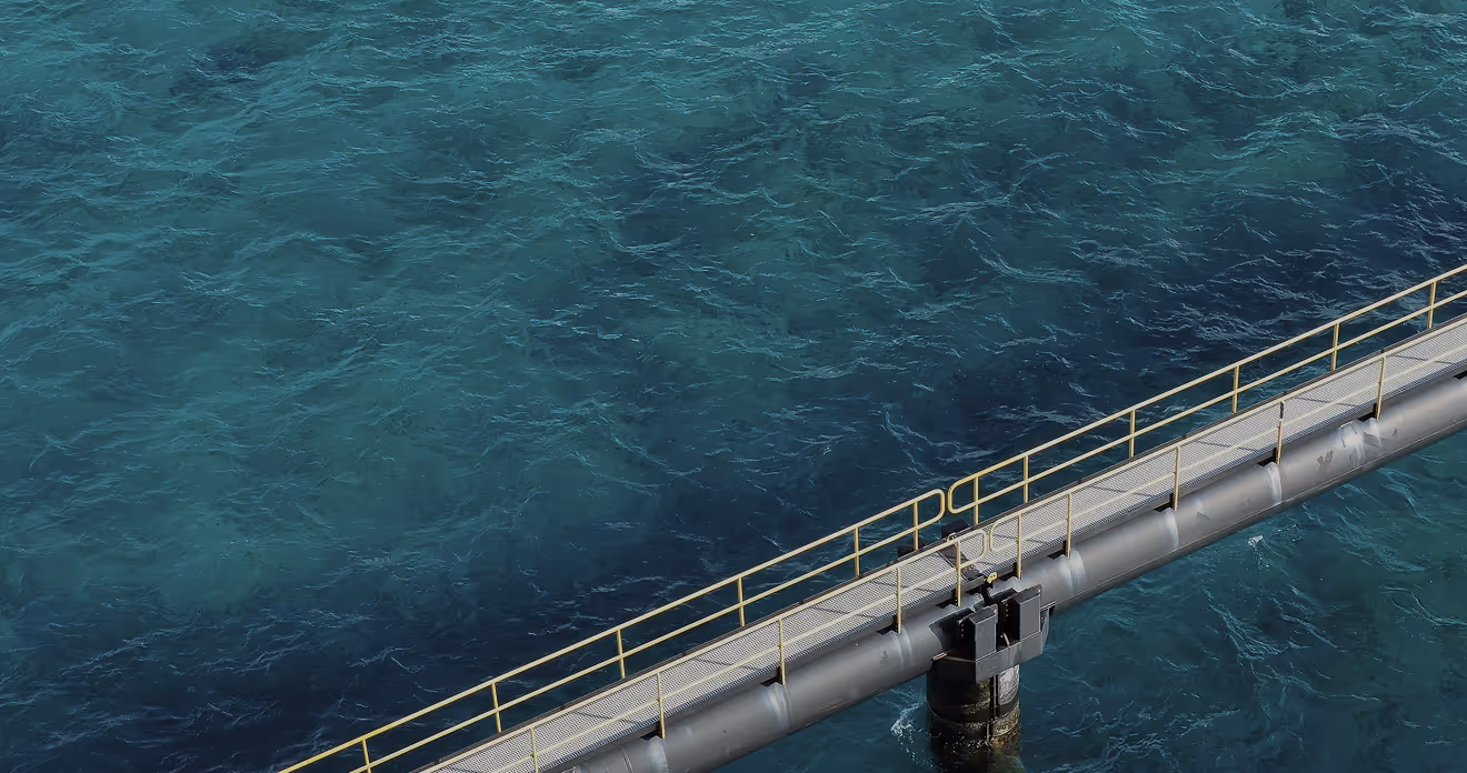 Yellow railing metal walkway extends over tranquil turquoise ocean water scene.