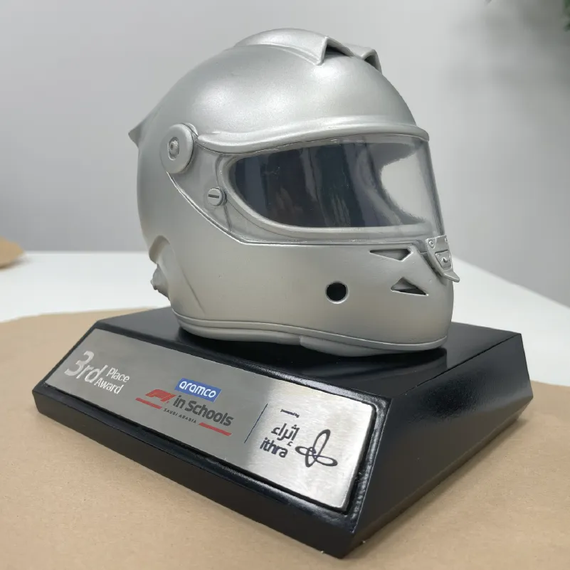 Silver racing helmet trophy on black base with plaque reading 3rd Place Award for Aramco F1 in Schools.