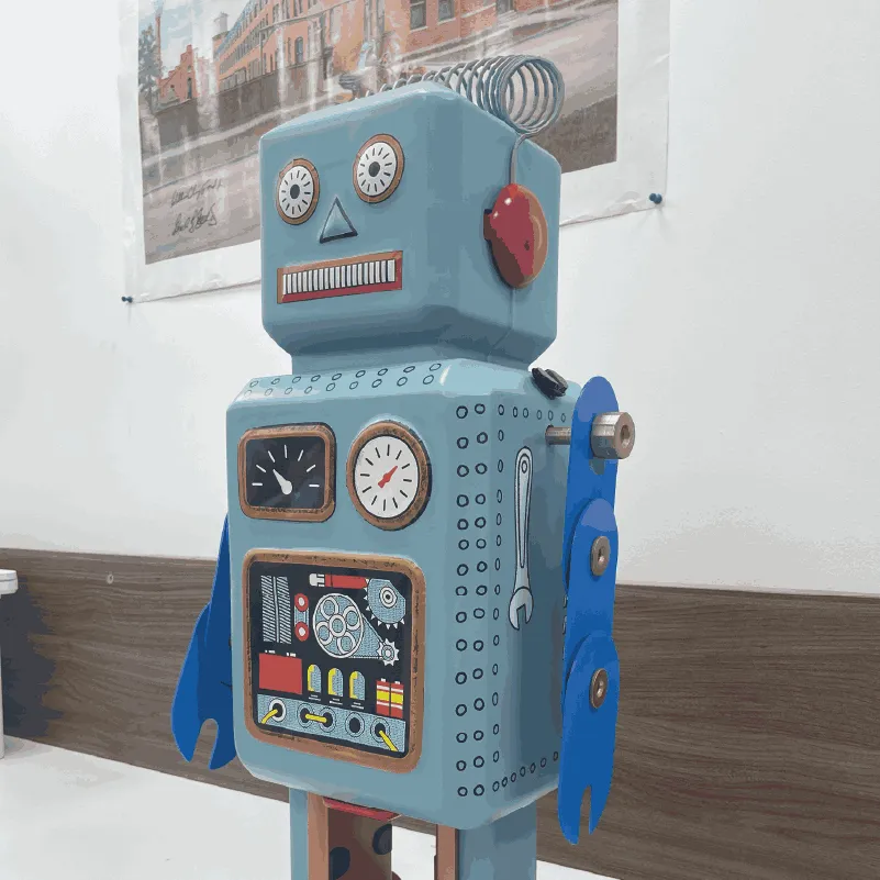Vintage-style blue toy robot with dials, gears, and blue claw arms standing indoors.