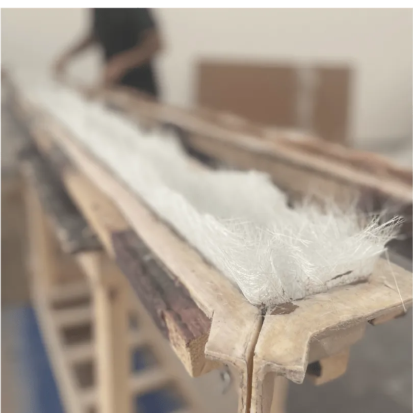 Close-up of long wooden structure with white fibrous material inside on a wooden stand.