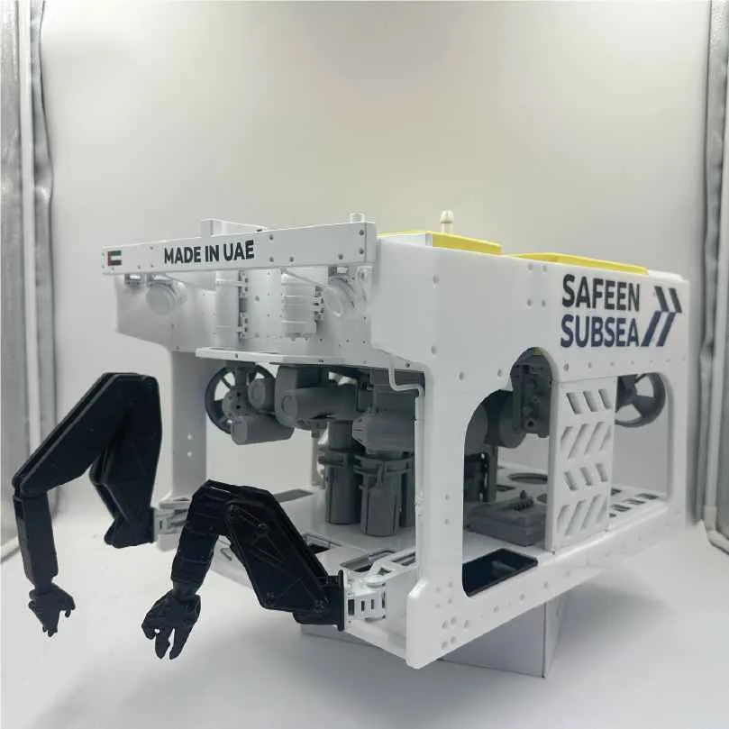 White underwater remotely operated vehicle with robotic arms labeled Safeen Subsea, made in UAE.