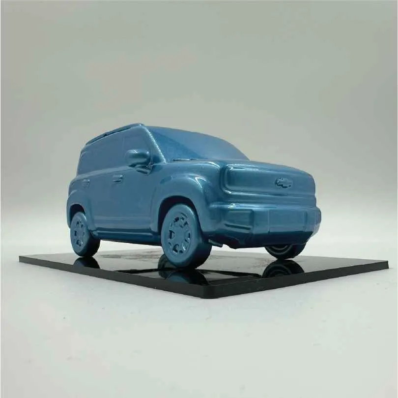 Blue glossy toy SUV model on a black square platform against a plain background.