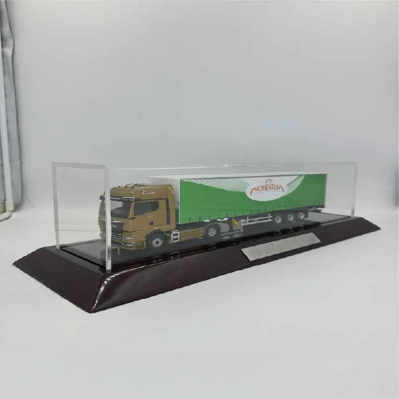 Brown and green Momentum semi-truck model displayed in a clear acrylic case on a black base.