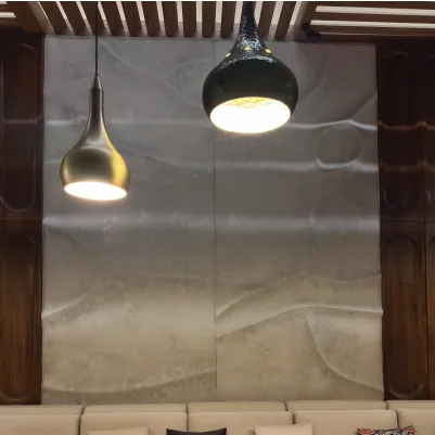 Modern room wall with two hanging pendant lights and a beige cushioned sofa below.