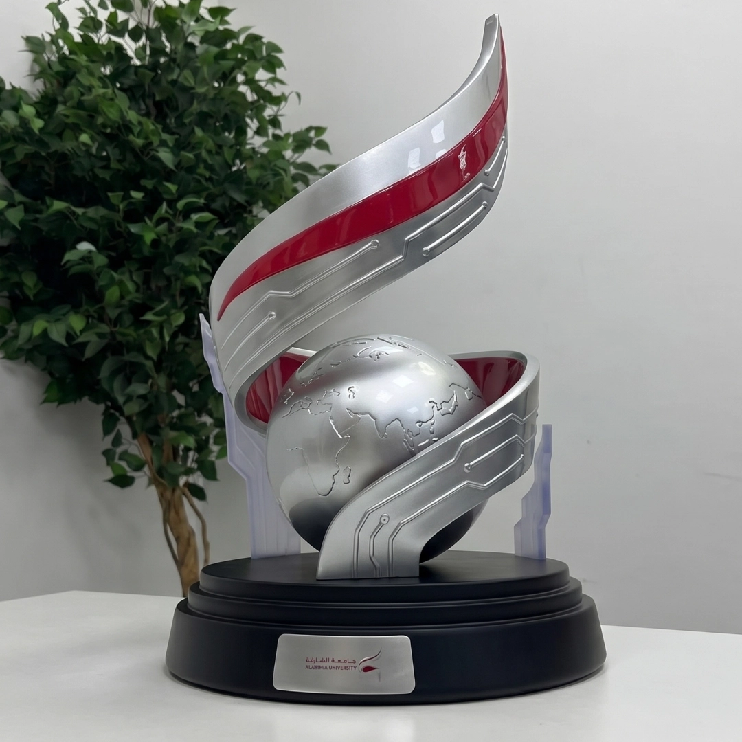 Silver event award with a globe motif on a black base
