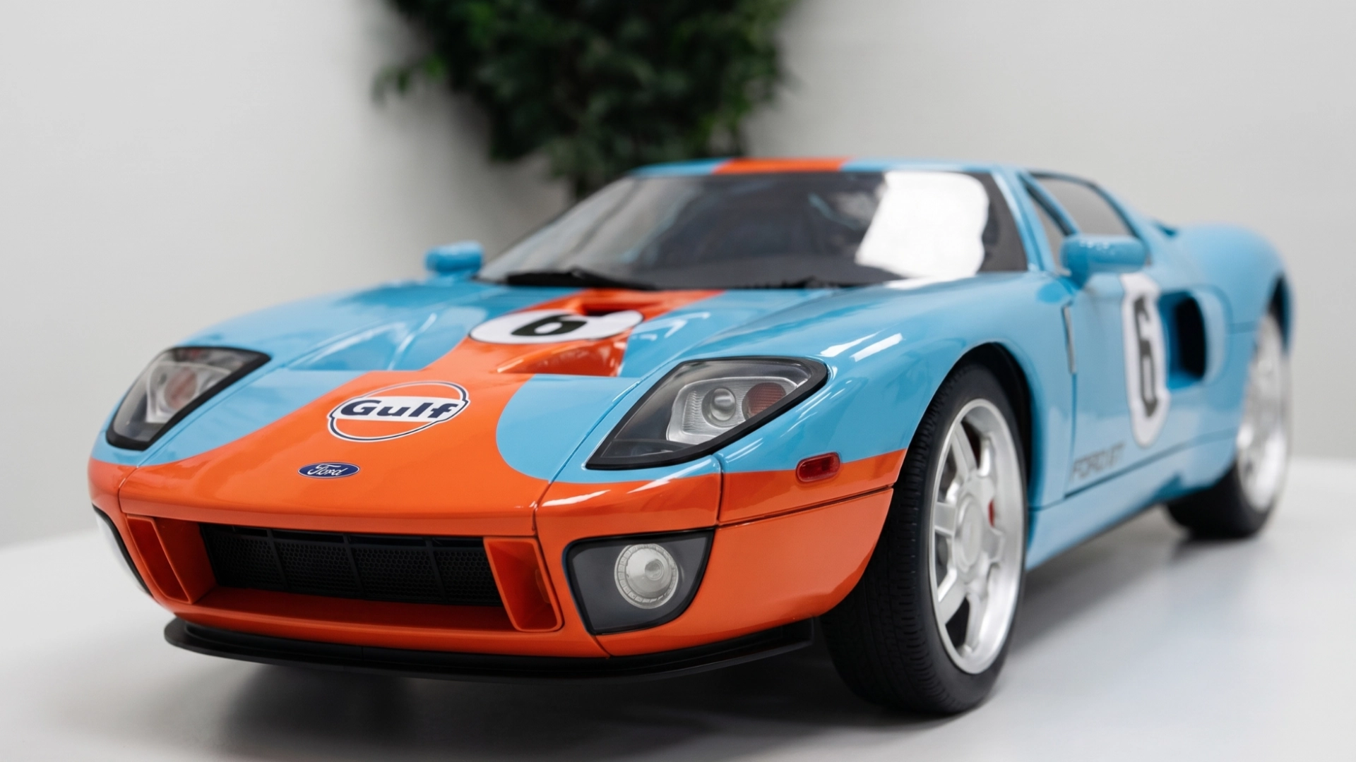 Full-scale race car replica in blue and orange livery, reproduced from reference geometry.