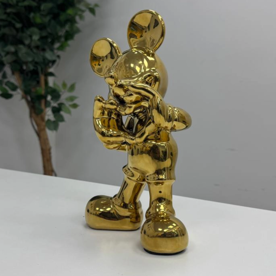 Detail of a gold-finished character sculpture.