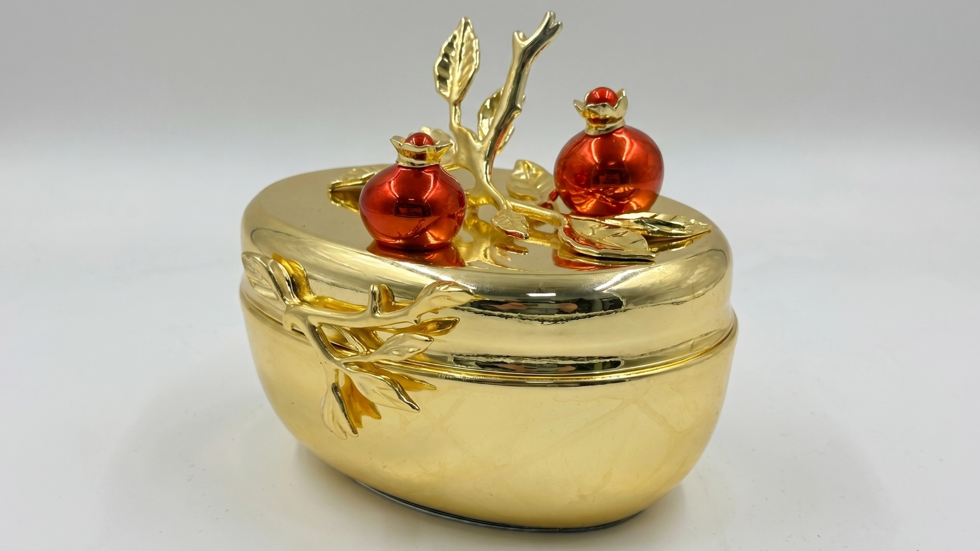 Gold-toned decorative piece with a polished metallic finish