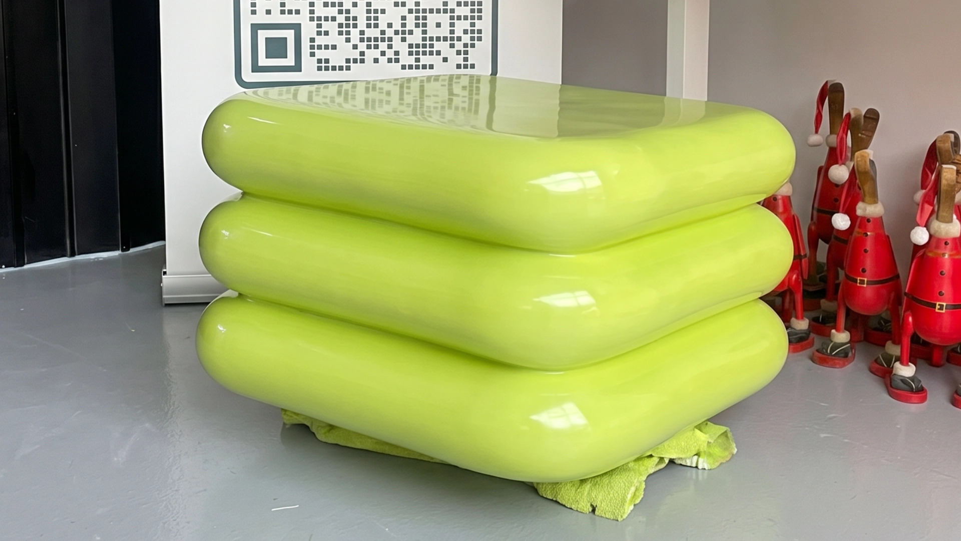 Green abstract sculpture with organic sculpted forms.