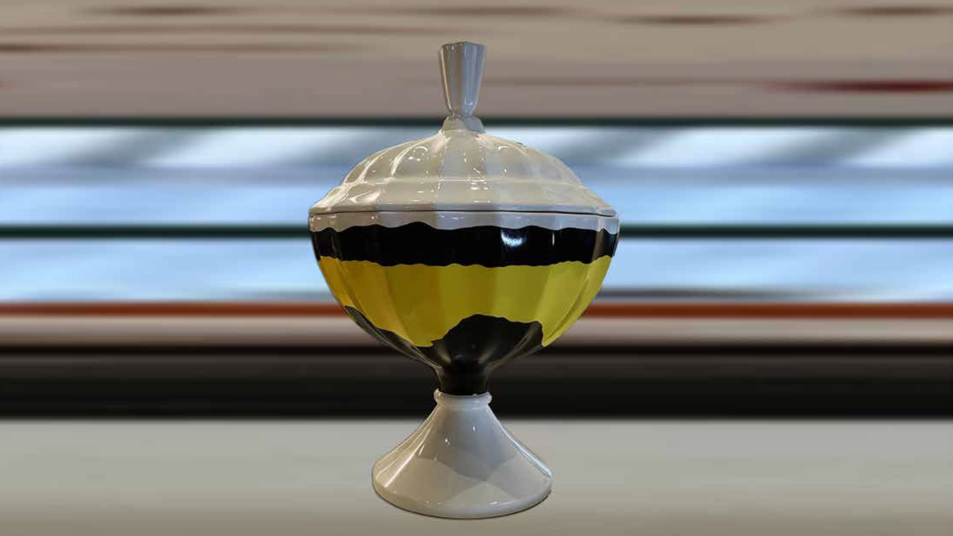 Striped decorative container prop with a smooth painted finish