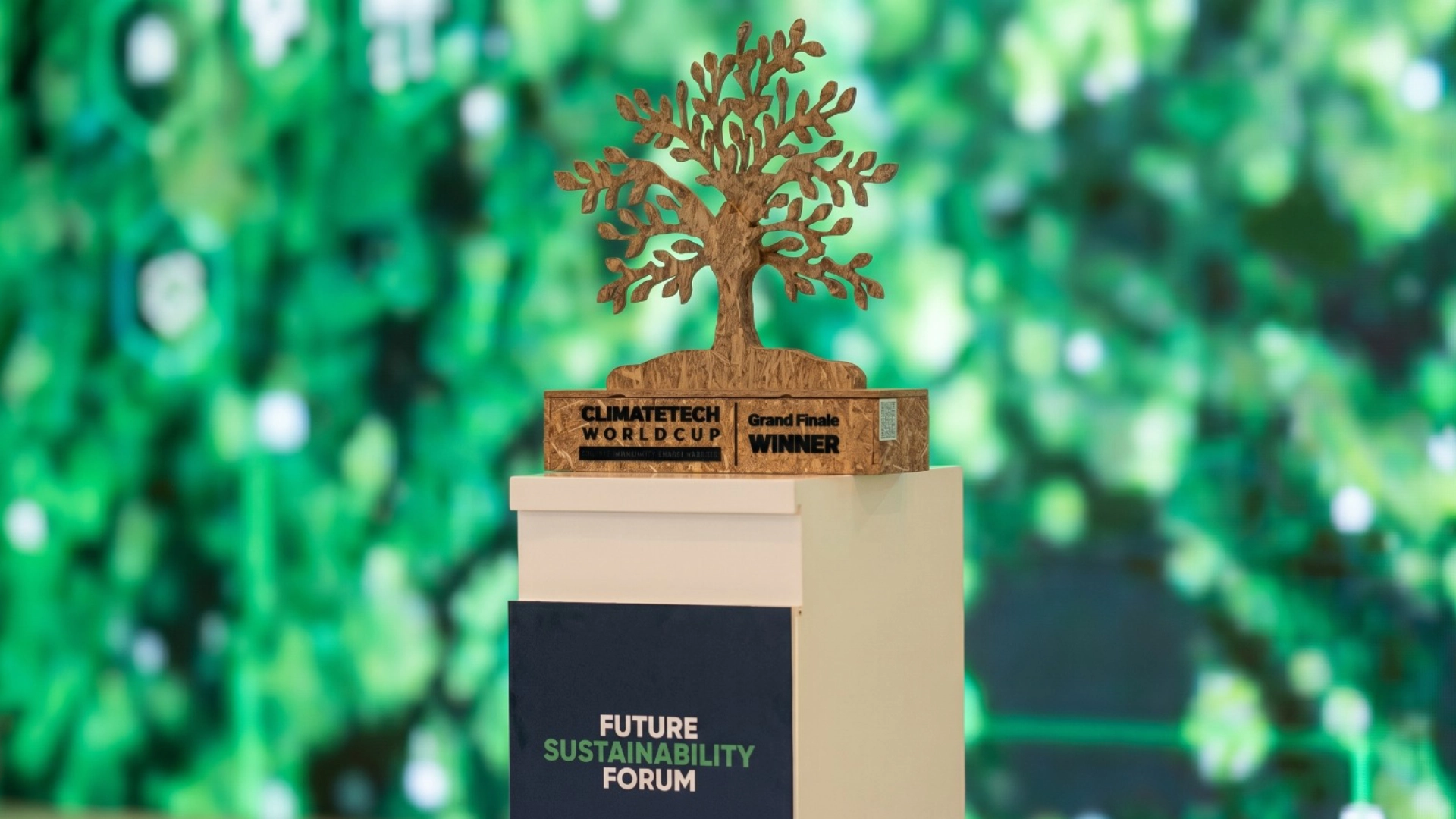Wooden tree-shaped award on a white pedestal