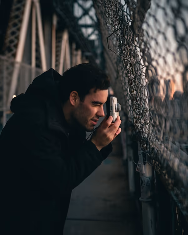 man in black jacket holding smartphone