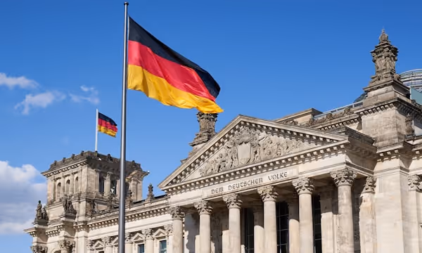 Close-up Deutscher Reichstag with german national flags