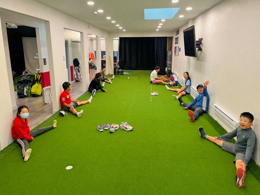 7 students stretching in a classroom