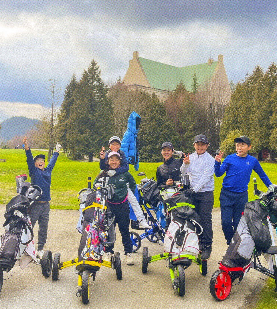 6 students smiling next to their golf push carts at an outdoor tournament