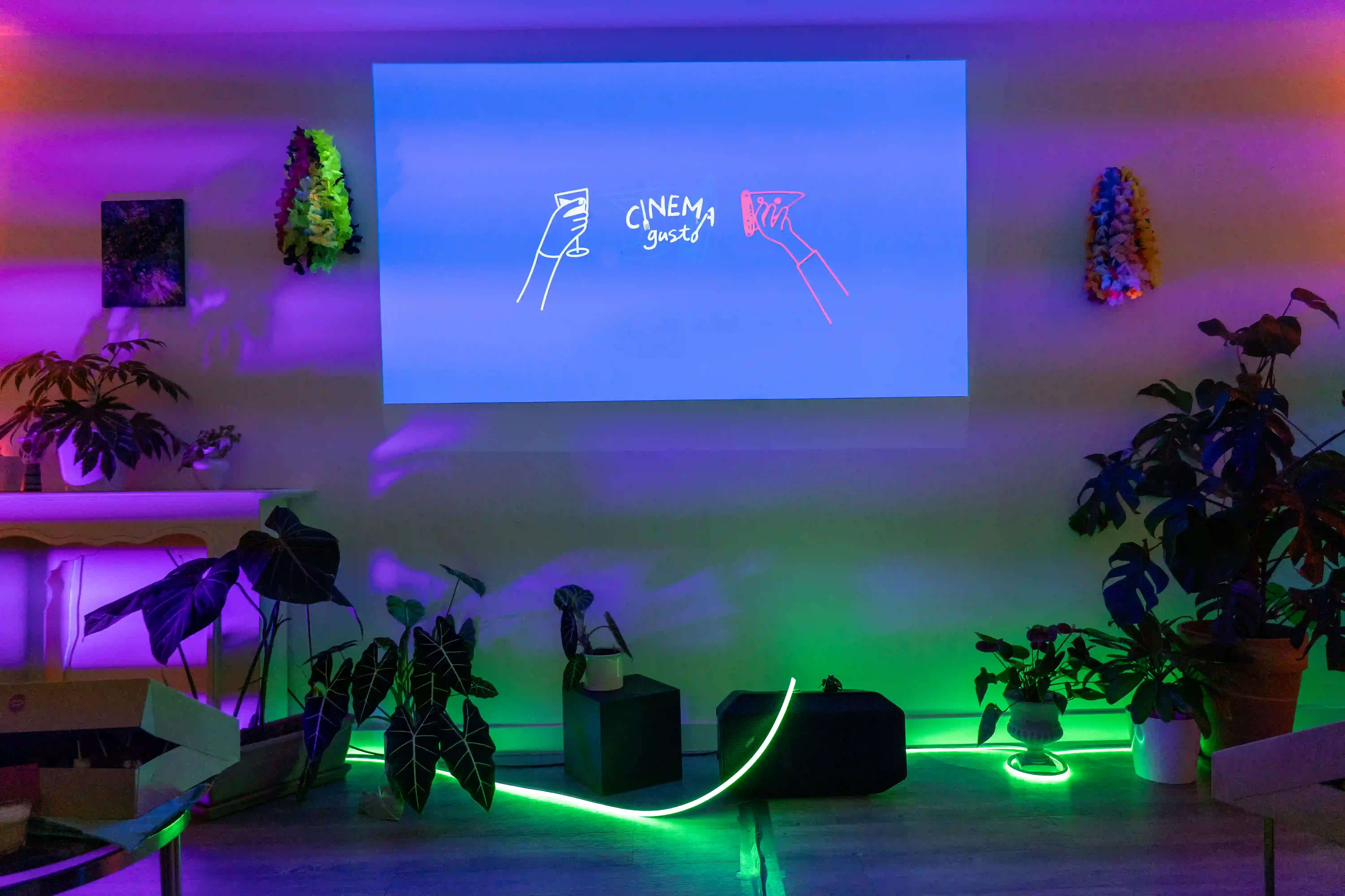 White table with drawings of arms holding cocktail glasses, one real empty glass on a coaster at the top right, and five empty glasses lined up at the top.