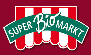 Green curved banner with 'Super Biomarkt' text over a red and white striped awning.