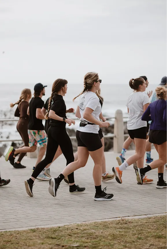 A community group run taking place on the sea point promenade.