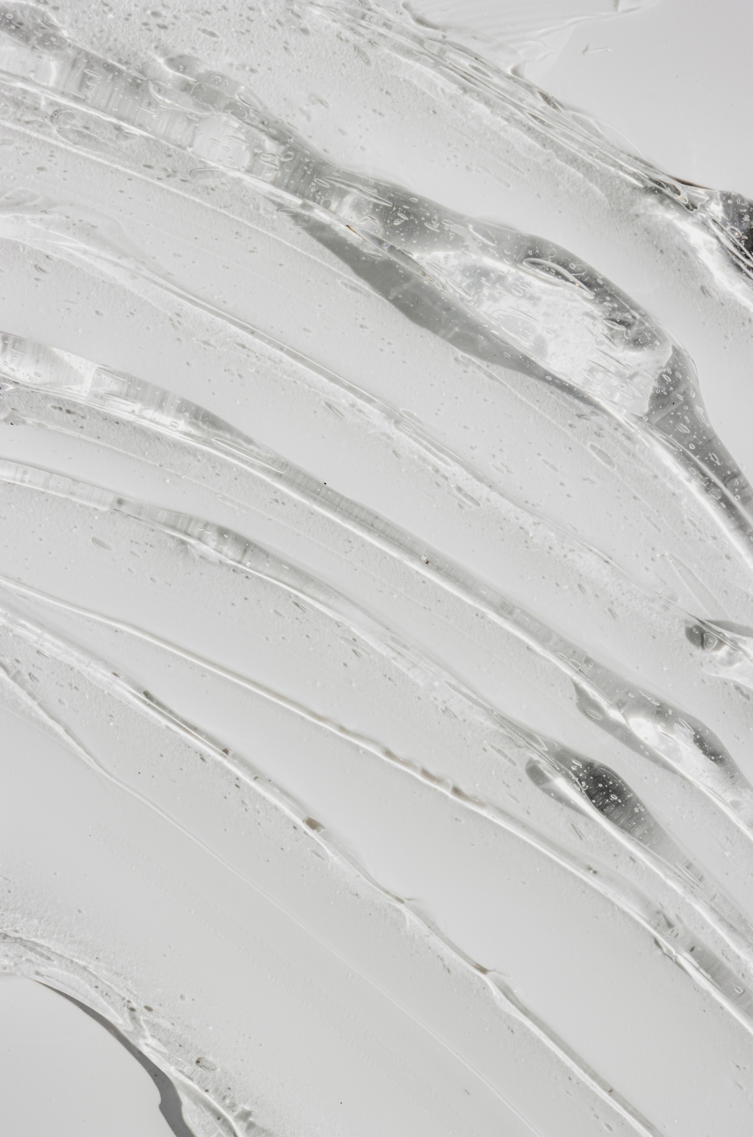 Close-up of translucent ice with layered, flowing texture and crystalline patterns