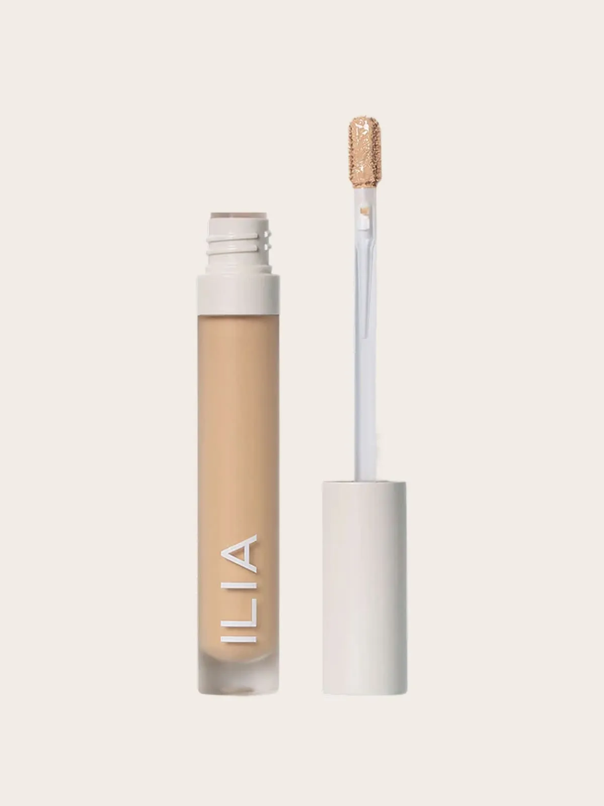 Ilia concealer bottle with wand, light beige makeup product