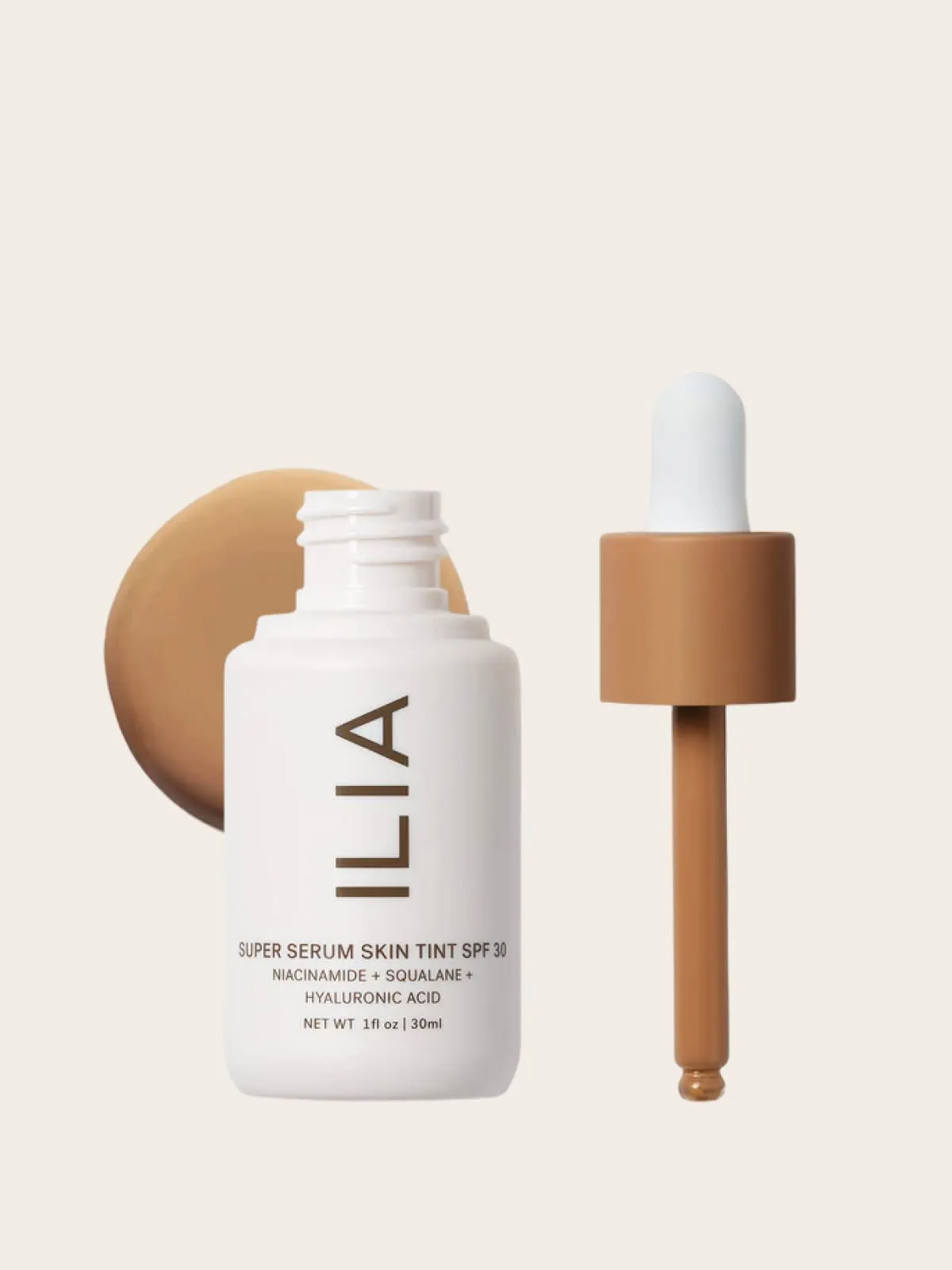 Ilia Super Serum Skin Tint SPF 30 with dropper and product background