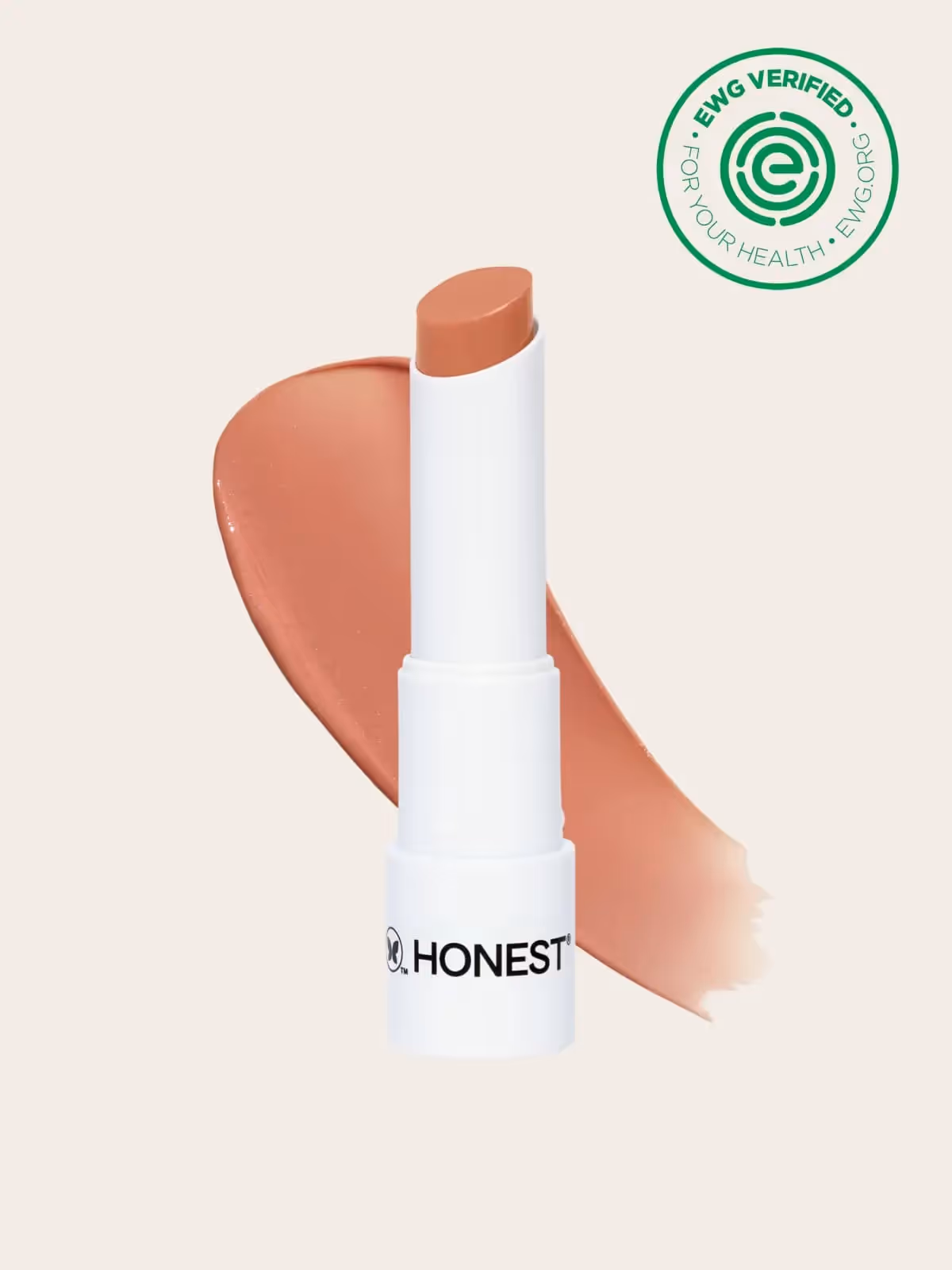 White Honest Beauty lip balm tube with peach-colored smear and EWG verified logo