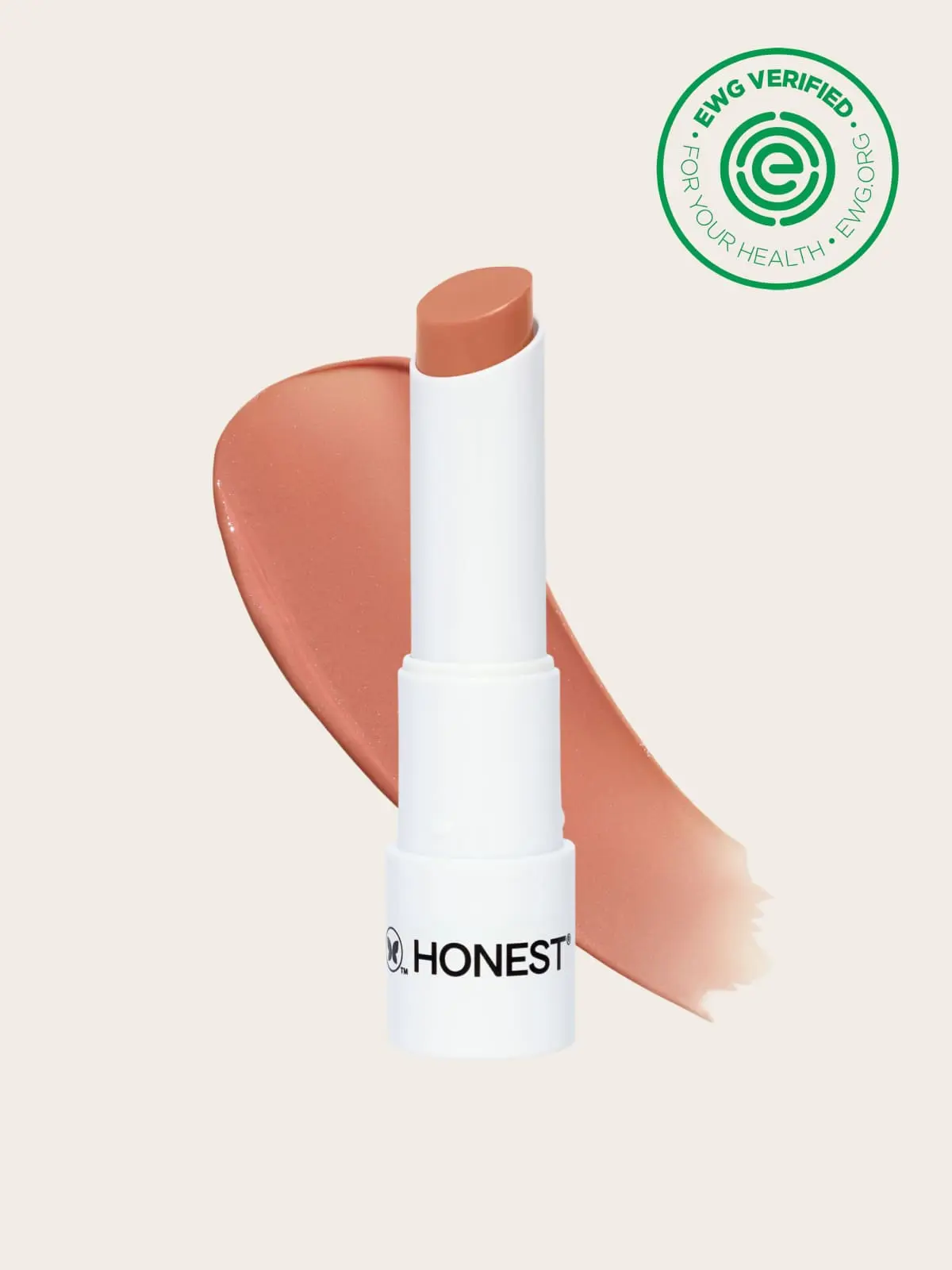 White Honest Beauty lip balm tube with peach-colored smear and EWG verified logo