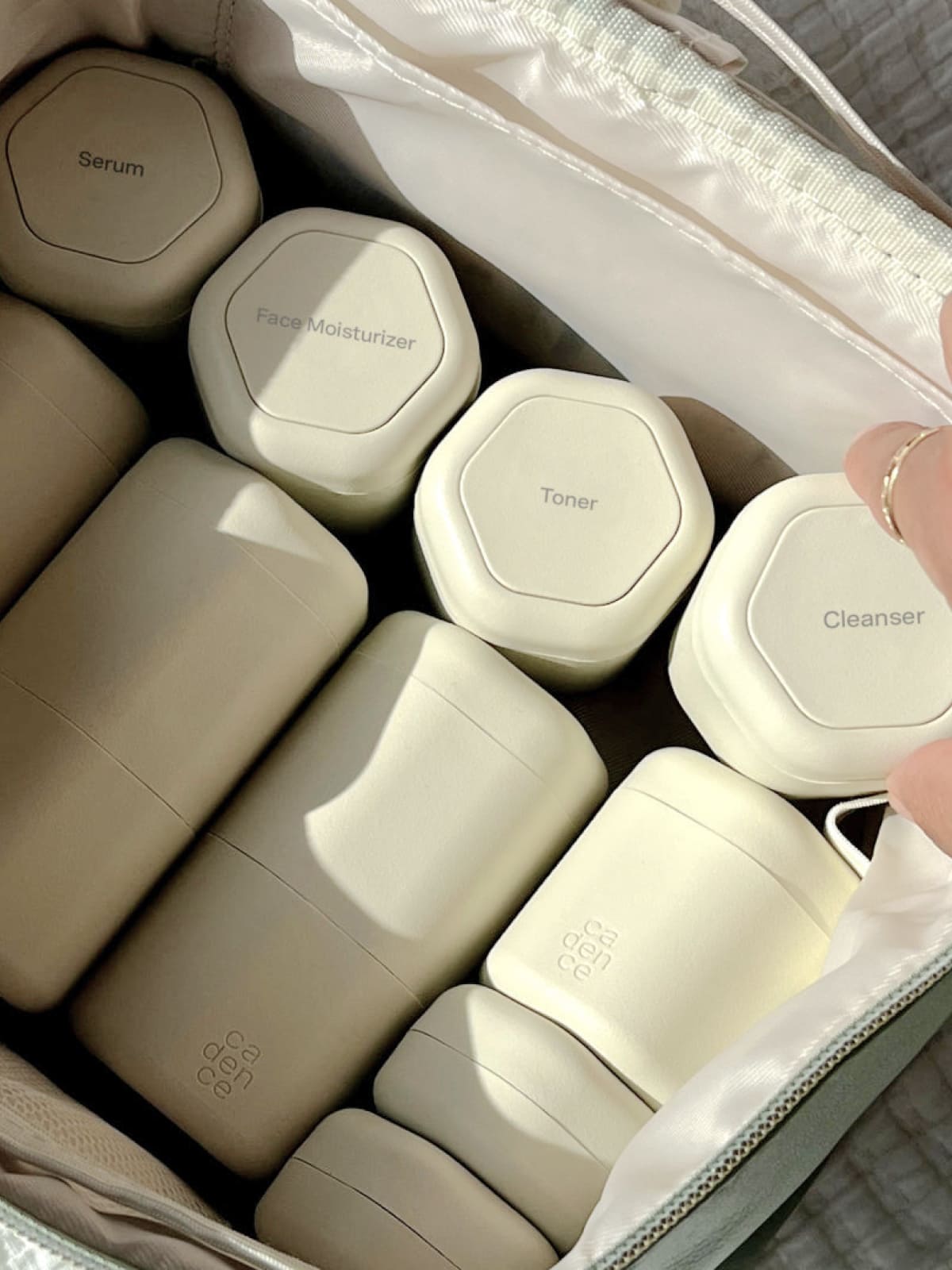 Minimalist skincare products in neutral tones arranged in an organized case
