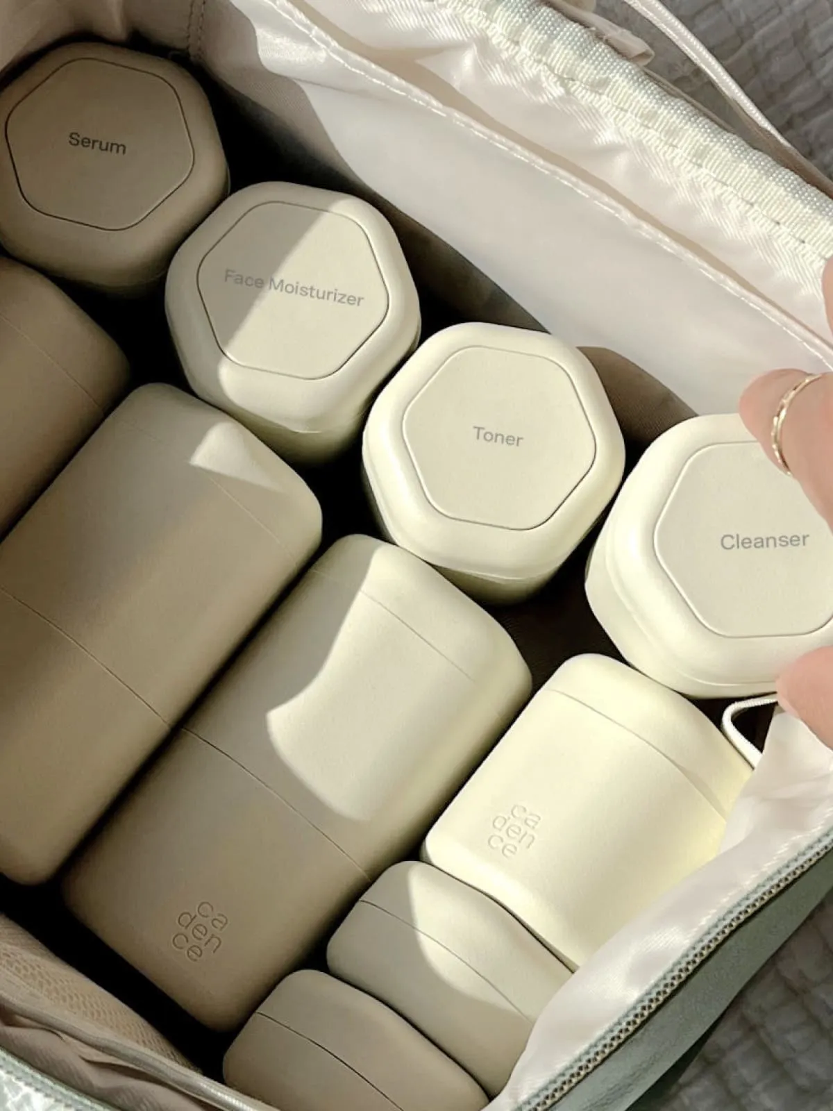 Minimalist skincare products in neutral tones arranged in an organized case