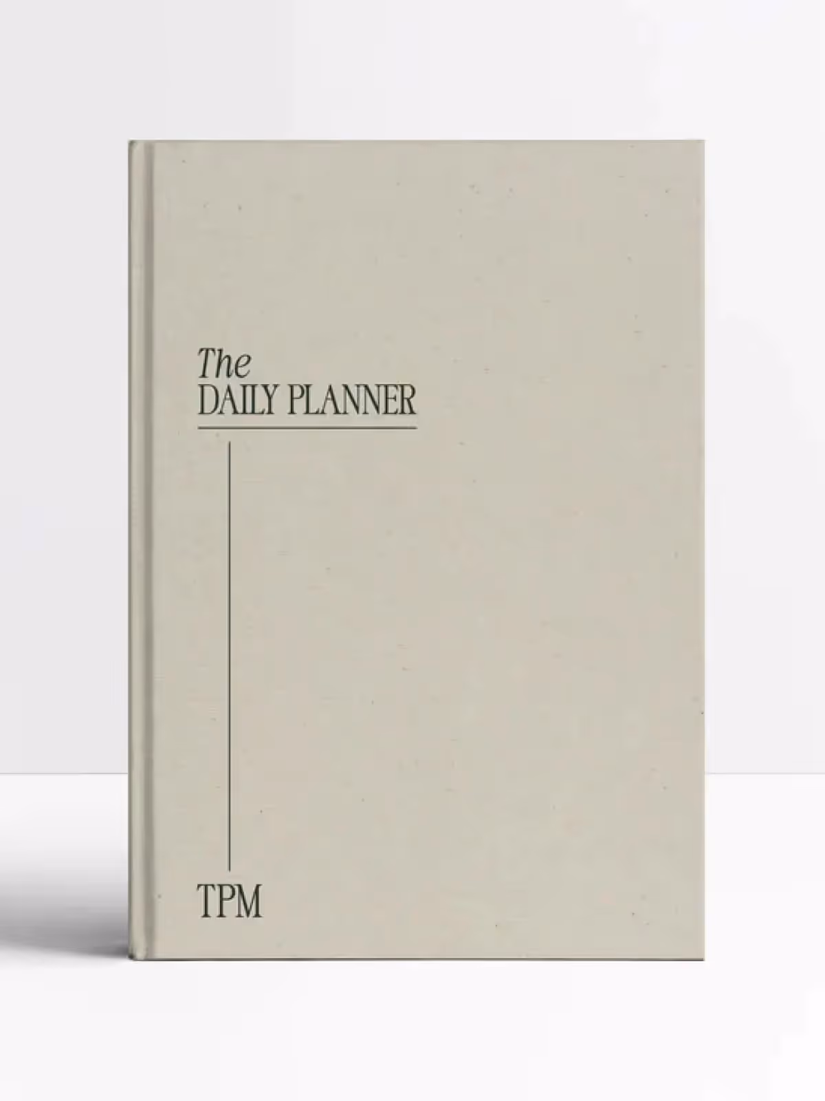 Light green daily planner book with TPM initials on cover