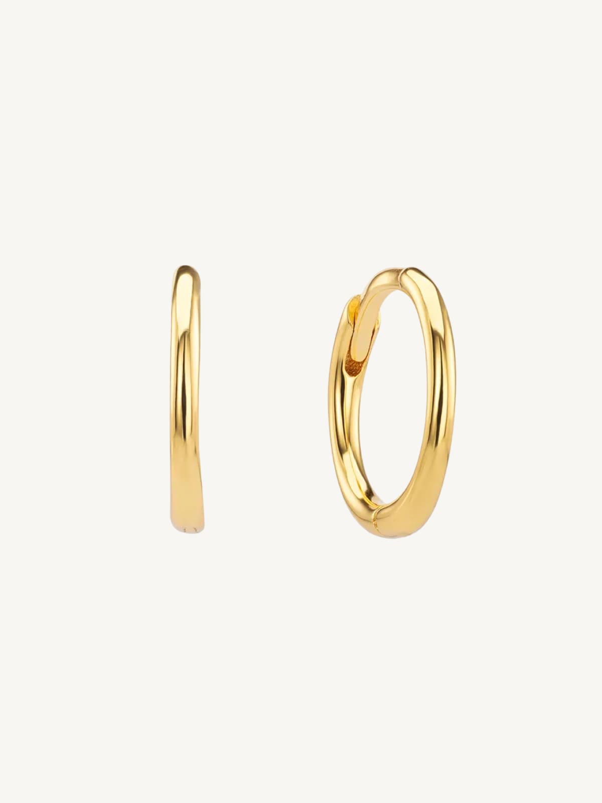 Gold small hoop earrings on a white background