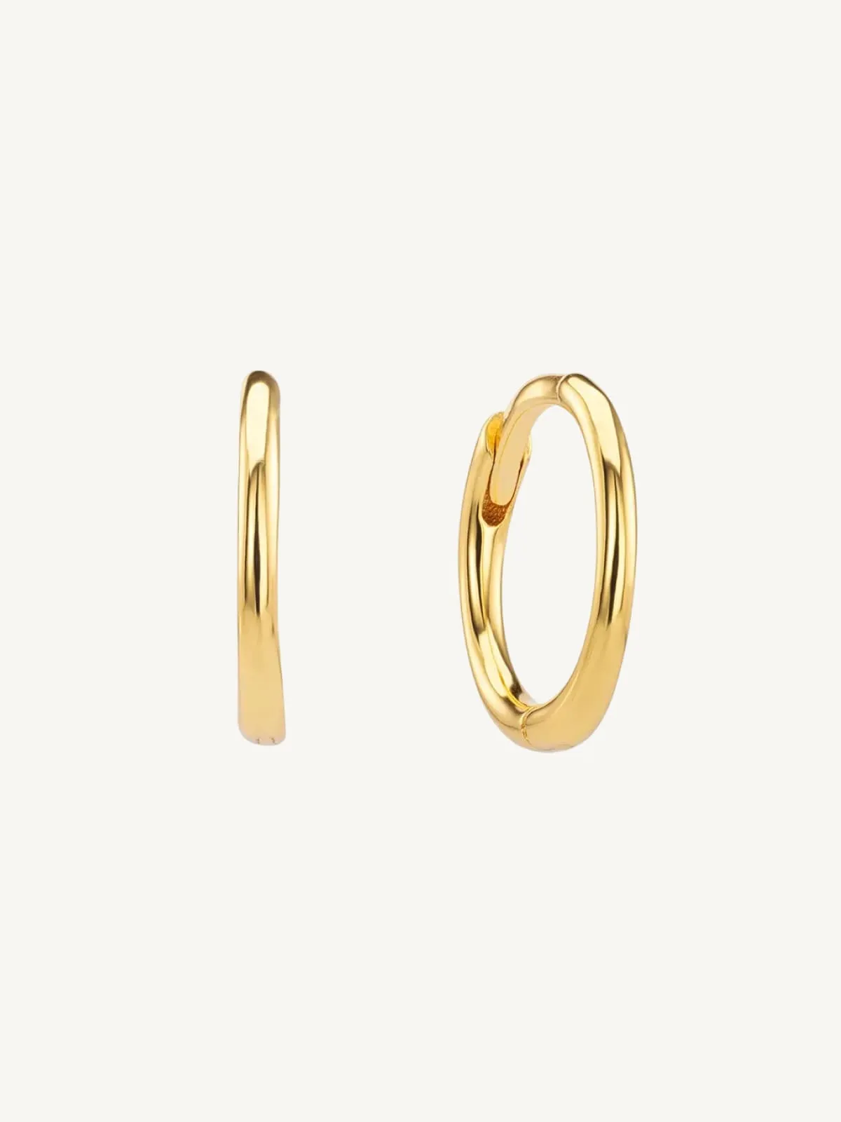 Gold small hoop earrings on a white background
