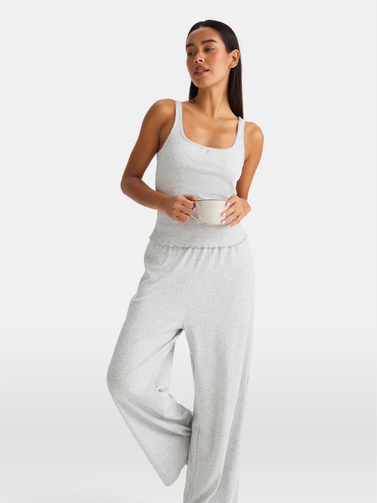 Woman in light gray ribbed tank top and wide-leg lounge pants