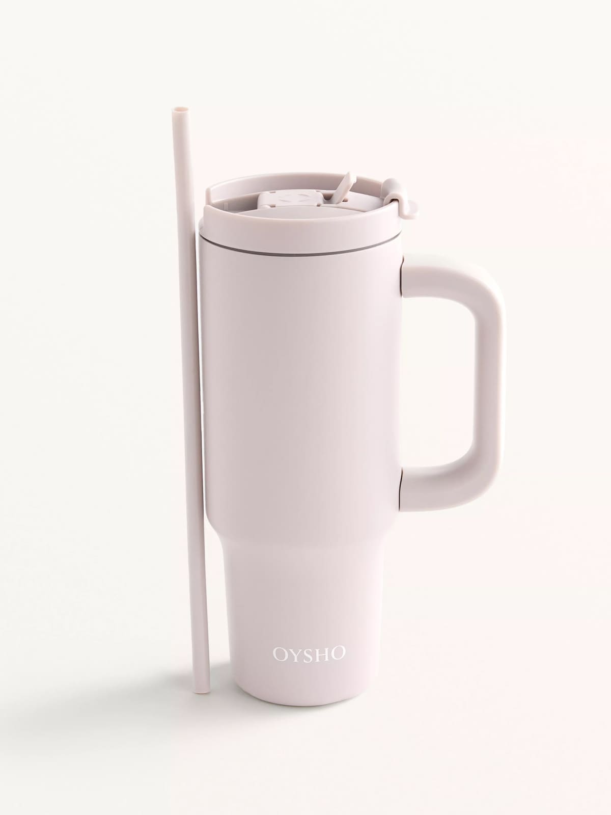 White Oysho tumbler with lid and straw on minimalist background