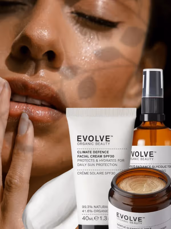 Woman applying Evolve organic beauty skincare products with SPF30 facial cream and radiance serum.