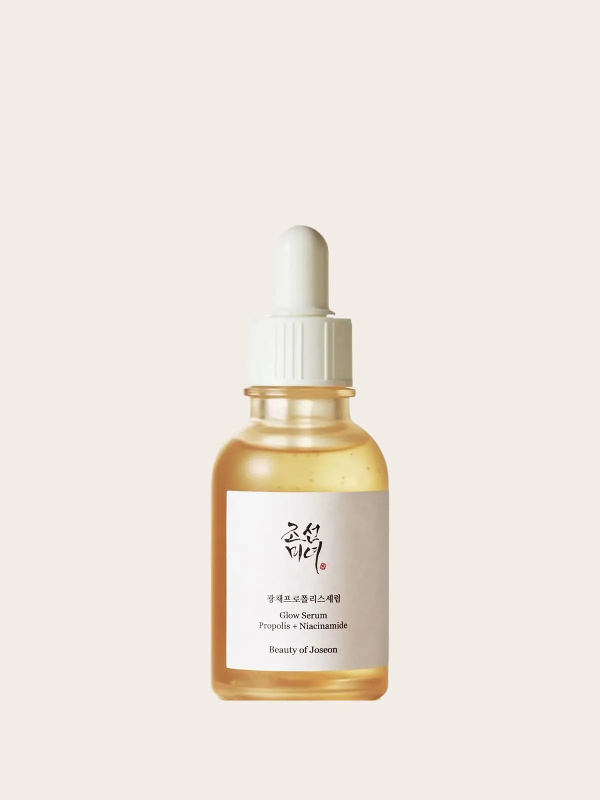 Golden propolis and niacinamide serum bottle with white dropper cap against beige background