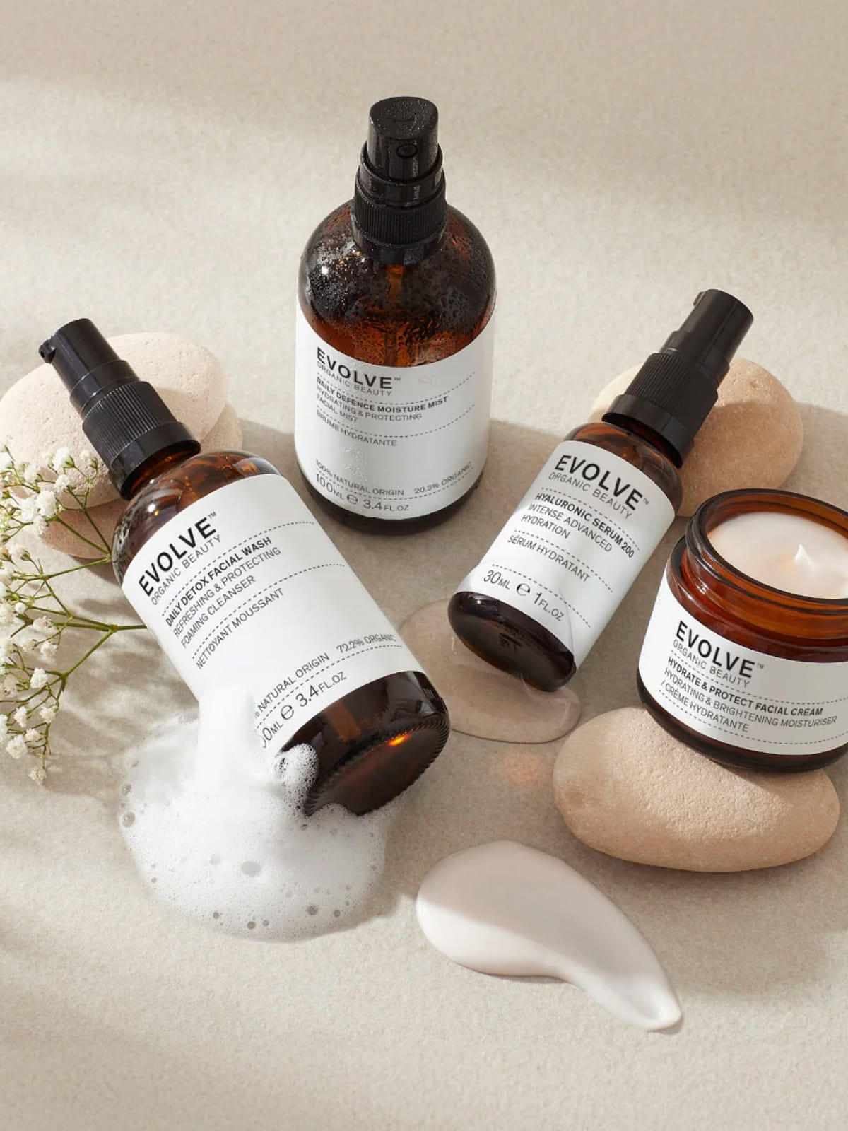 Collection of Evolve skincare products with amber bottles and jars on neutral background