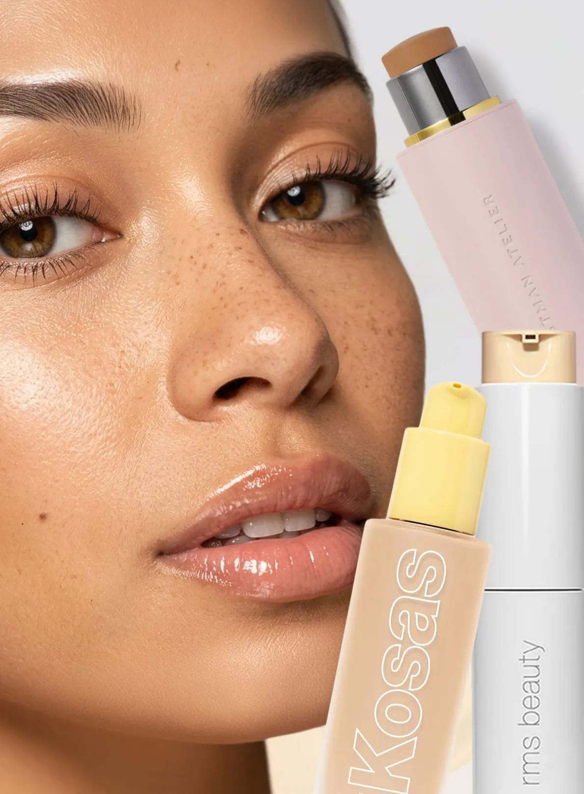 Woman with freckles and long lashes displaying Kossas beauty makeup foundation products