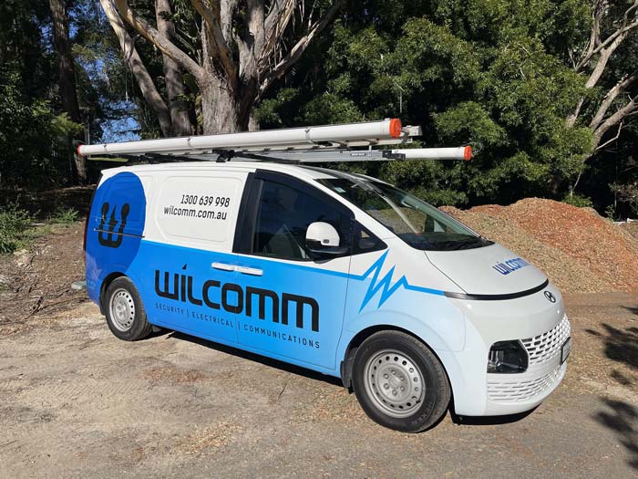 Wilcomm Technician Installing a Security System in Sydney