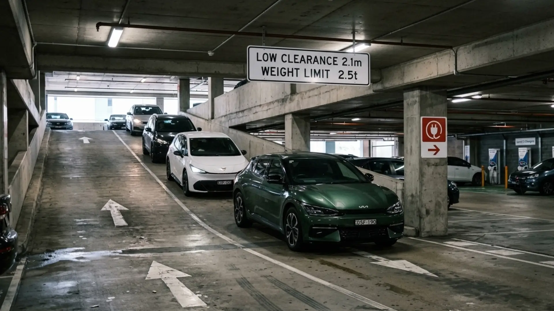 A congested queue of electric vehicles in a Sydney parking garage highlighting public charging delays. High Demand Electrical provides expert home EV charger installations and Level 2 switchboard upgrades to help drivers avoid public network congestion.