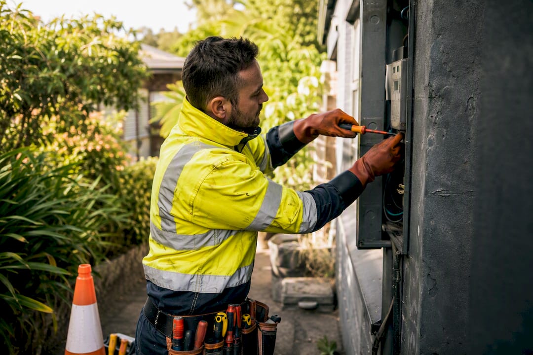 Electrician unscrewing meter during outage