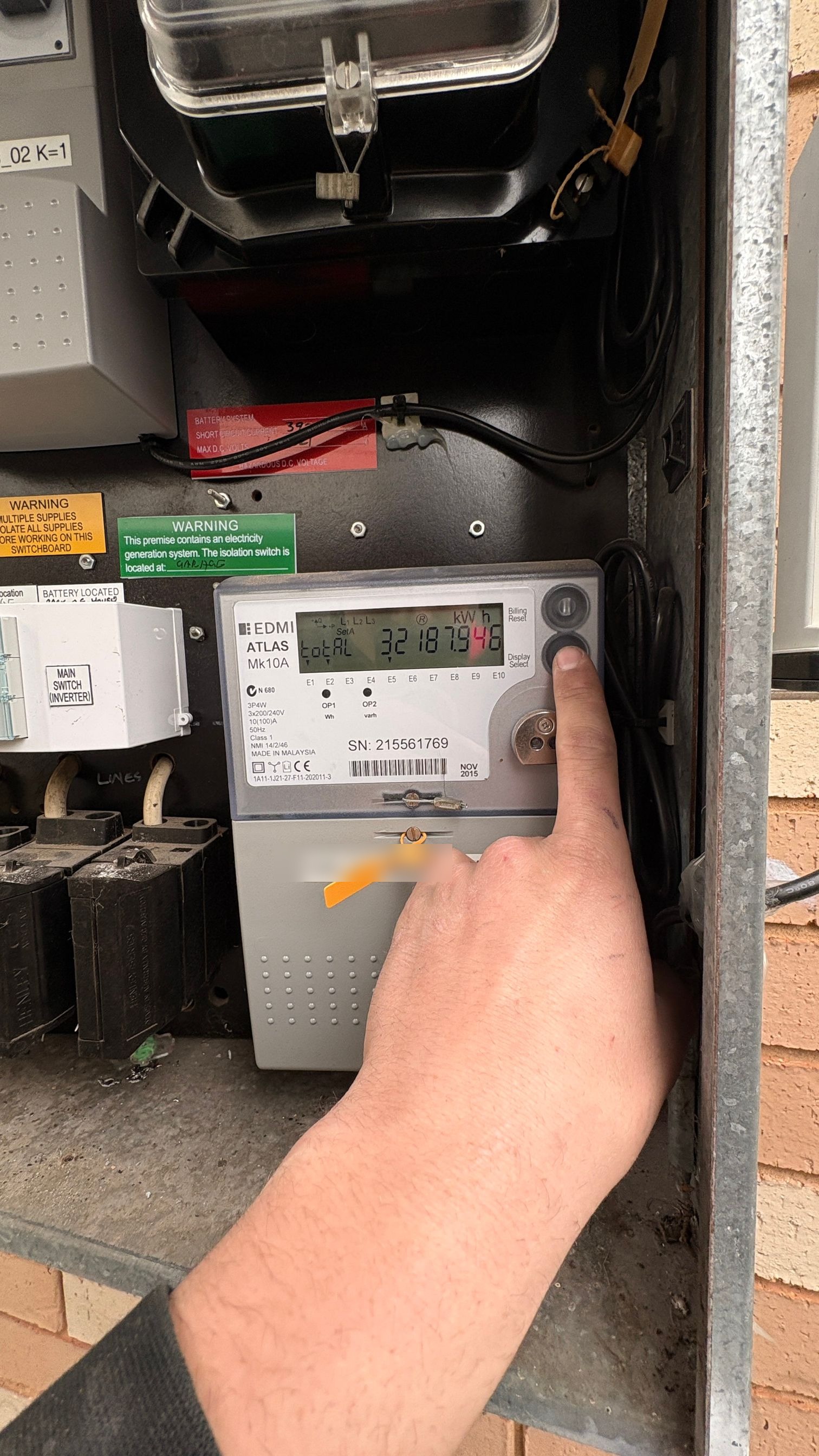 Technician checking the meter after relocating a hot water circuit off controlled load in Canley Vale NSW