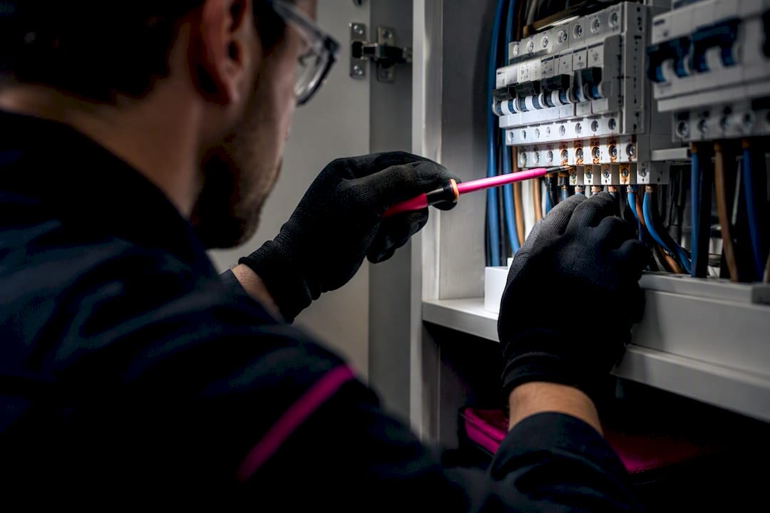 Electrician inspecting residential switchboard termination