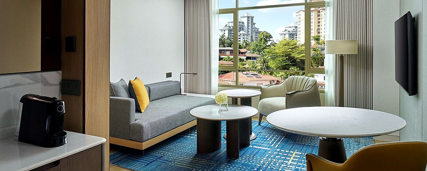 Suite living room with sofa and round tables