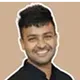 A man in a black shirt smiling at the camera.