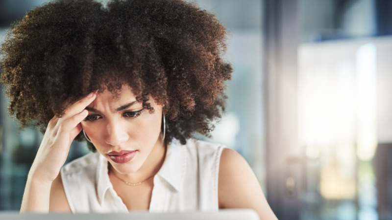 mixed race woman frustrated looking at computer screen
