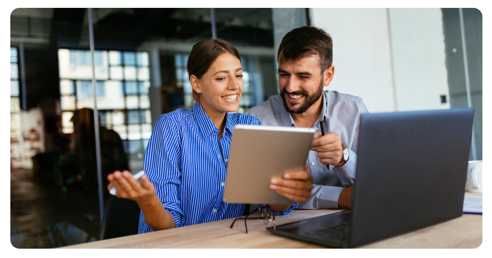 two people looking at an iPad with 